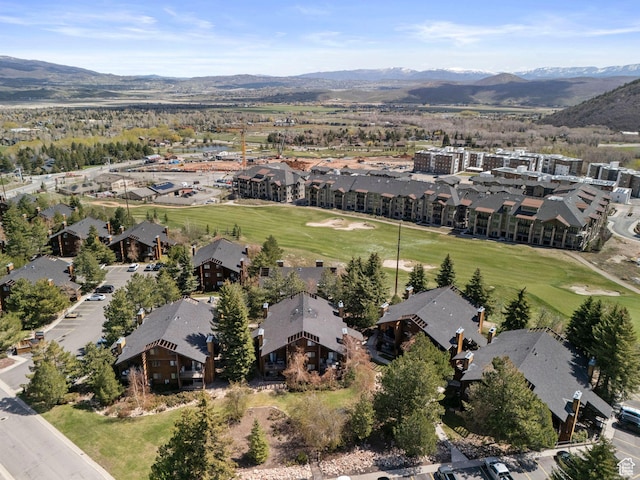 aerial view of property's location with a mountain backdrop and nearby suburban area