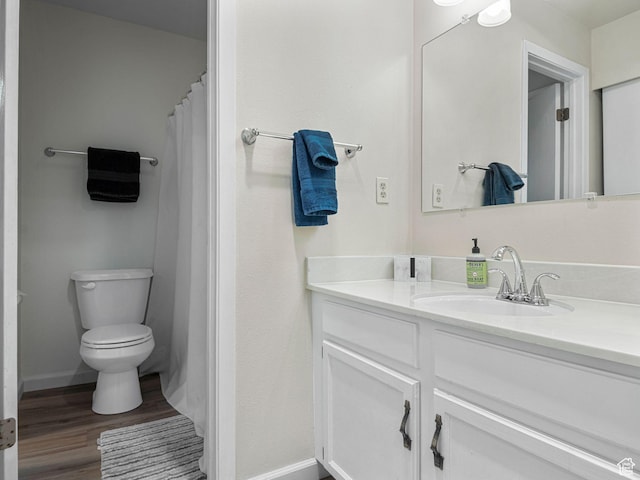 full bath featuring baseboards, vanity, toilet, and wood finished floors