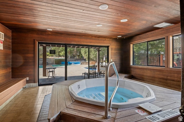 deck with a hot tub and a patio