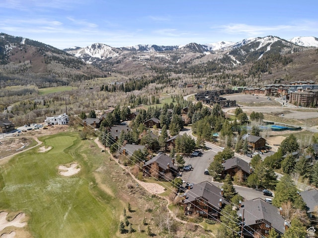 aerial overview of property's location featuring mountains and a local golf course
