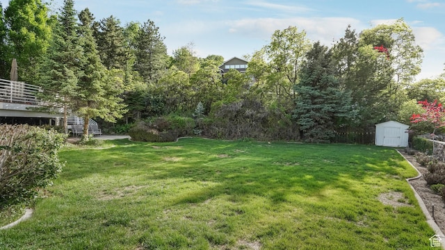 10804 S Lostwood Dr, Sandy, UT 84092 - view of grassy yard with a storage unit and an outbuilding