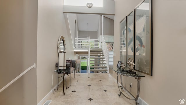 10804 S Lostwood Dr, Sandy, UT 84092 - corridor featuring a towering ceiling, baseboards, and tile patterned floors