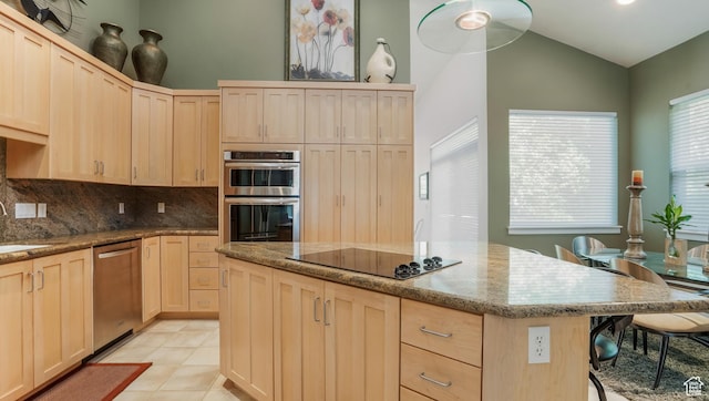 10804 S Lostwood Dr, Sandy, UT 84092 - kitchen featuring light brown cabinetry, appliances with stainless steel finishes, vaulted ceiling, light stone counters, and tasteful backsplash
