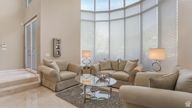 10804 S Lostwood Dr, Sandy, UT 84092 - living room featuring a towering ceiling, light marble finish floors, and baseboards
