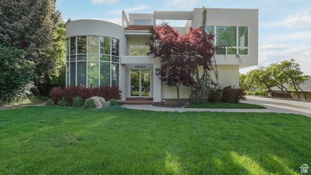 10804 S Lostwood Dr, Sandy, UT 84092 - view of front facade featuring stucco siding, a front lawn, and concrete driveway