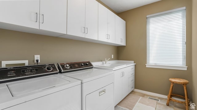 10804 S Lostwood Dr, Sandy, UT 84092 - laundry area with cabinet space, washer and dryer, baseboards, and light tile patterned floors