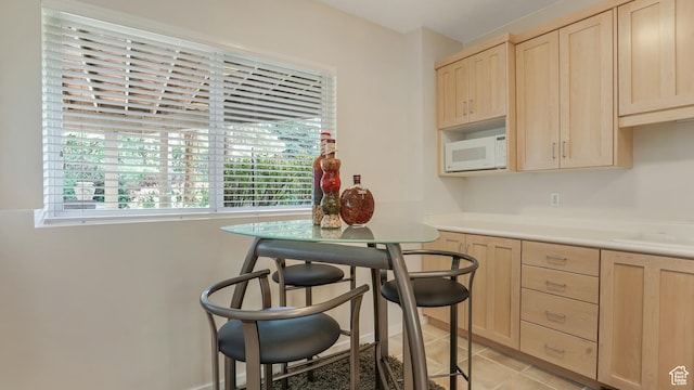 10804 S Lostwood Dr, Sandy, UT 84092 - kitchen featuring light brown cabinets, white microwave, light countertops, and light tile patterned floors