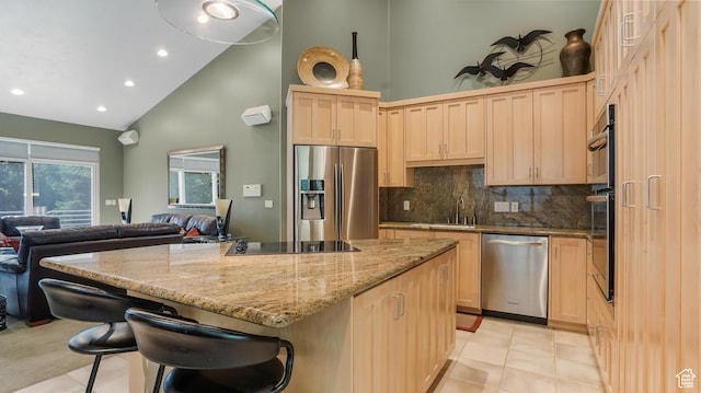 10804 S Lostwood Dr, Sandy, UT 84092 - kitchen with appliances with stainless steel finishes, light brown cabinets, high vaulted ceiling, a kitchen island, and a sink