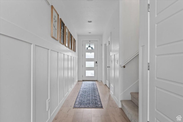 13741 S 3870 W, Riverton, UT 84065 - doorway to outside with light wood finished floors, stairs, and a decorative wall