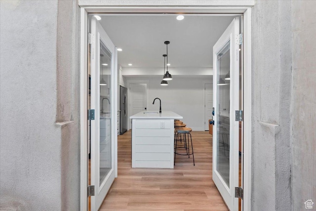 13741 S 3870 W, Riverton, UT 84065 - corridor featuring light wood-type flooring, a sink, and recessed lighting