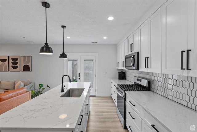 13741 S 3870 W, Riverton, UT 84065 - kitchen featuring appliances with stainless steel finishes, a sink, an island with sink, backsplash, and recessed lighting
