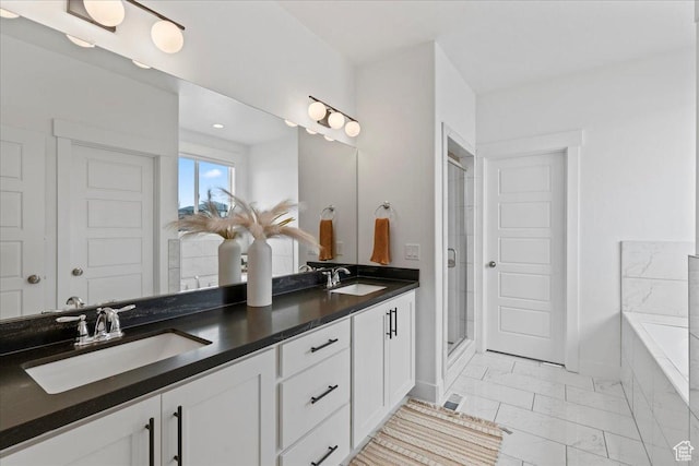 13741 S 3870 W, Riverton, UT 84065 - bathroom featuring marble look tiles, double vanity, a shower stall, a bath, and baseboards