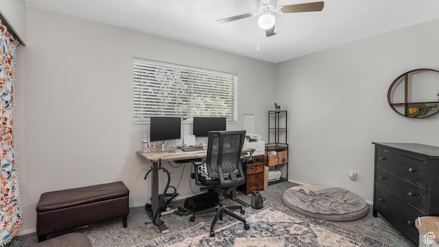 carpeted home office with a ceiling fan