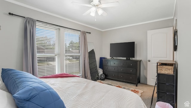 carpeted bedroom featuring ornamental molding and a ceiling fan