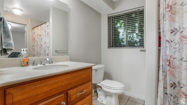 bathroom featuring tile patterned flooring, toilet, vanity, and curtained shower