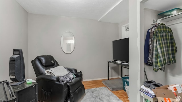 living area featuring wood finished floors and baseboards
