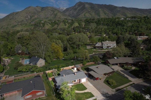 view of property location with a mountain backdrop and nearby suburban area