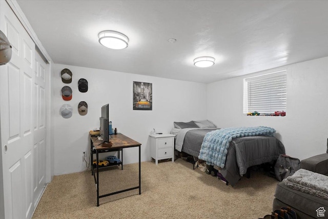 bedroom with light colored carpet and a closet