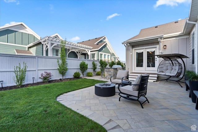 view of patio featuring a pergola, an outdoor living space with a fire pit, and french doors