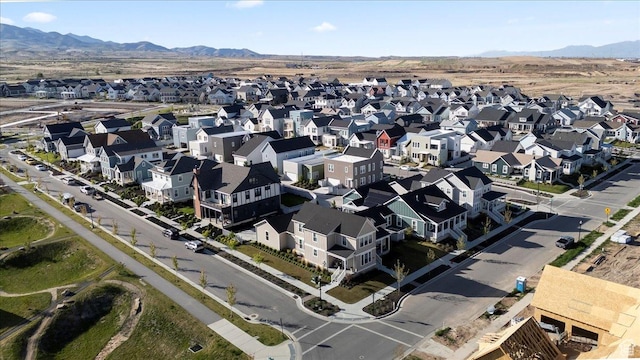 aerial view of property and surrounding area with mountains and nearby suburban area