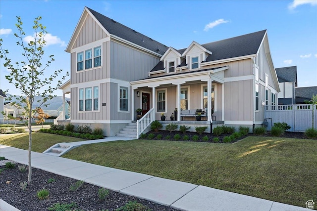 modern farmhouse with a porch, board and batten siding, and roof with shingles