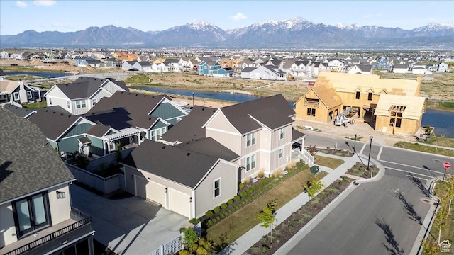 aerial view of residential area featuring a water and mountain view