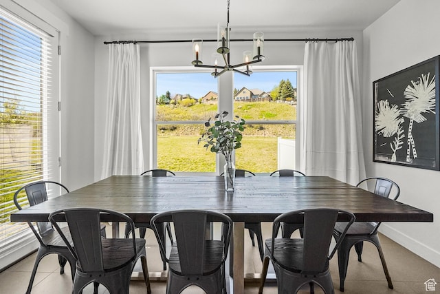 dining space with a chandelier and baseboards