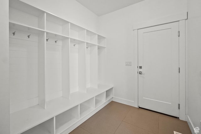 mudroom with baseboards and tile patterned flooring