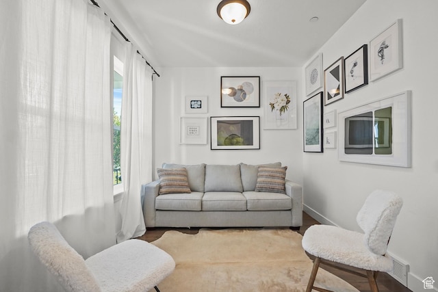 living room featuring baseboards and wood finished floors