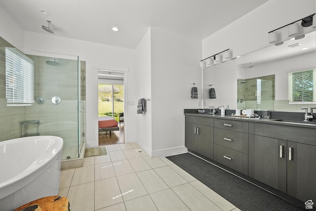 full bath featuring a shower stall, double vanity, healthy amount of natural light, and tile patterned flooring