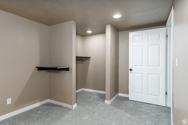walk in closet with carpet floors
