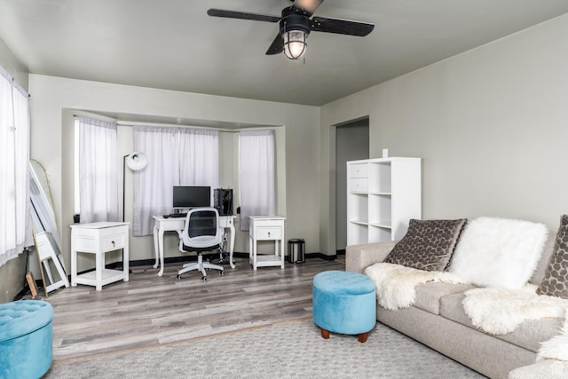 office area featuring ceiling fan, wood finished floors, and baseboards