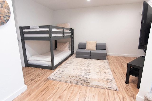bedroom featuring wood finished floors and baseboards