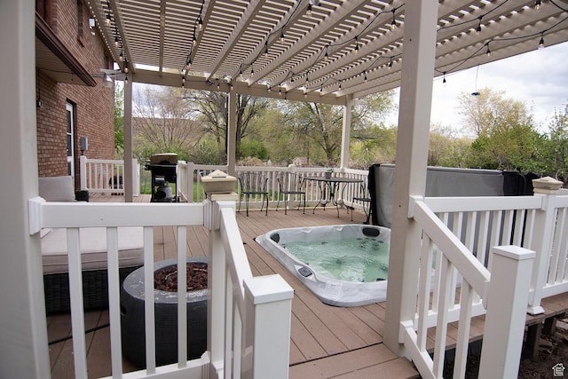 wooden terrace with an outdoor hot tub, a pergola, and a grill