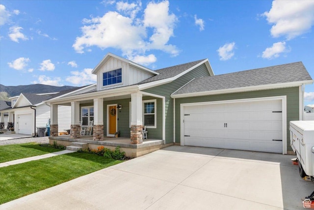 40 E 920 N, Santaquin, UT 84655 - view of front of house with board and batten siding, a porch, concrete driveway, an attached garage, and a mountain view