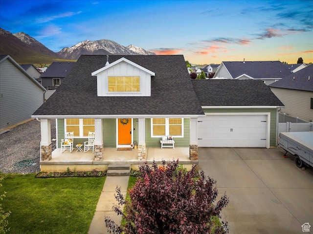 40 E 920 N, Santaquin, UT 84655 - view of front facade with a porch, an attached garage, driveway, a mountain view, and a shingled roof