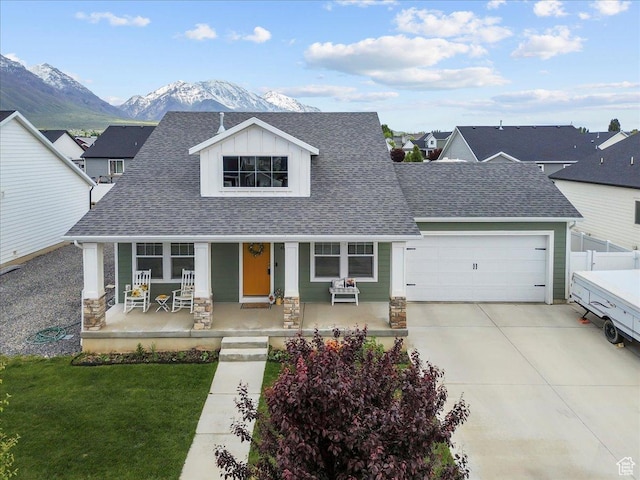 40 E 920 N, Santaquin, UT 84655 - view of front facade featuring a porch, a garage, a shingled roof, a mountain view, and concrete driveway