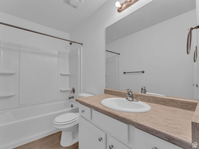 bathroom with toilet, vanity, and shower / washtub combination
