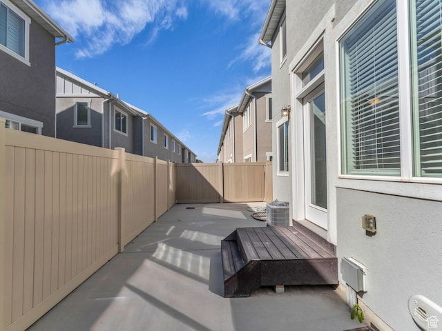 view of patio with fence and central air condition unit