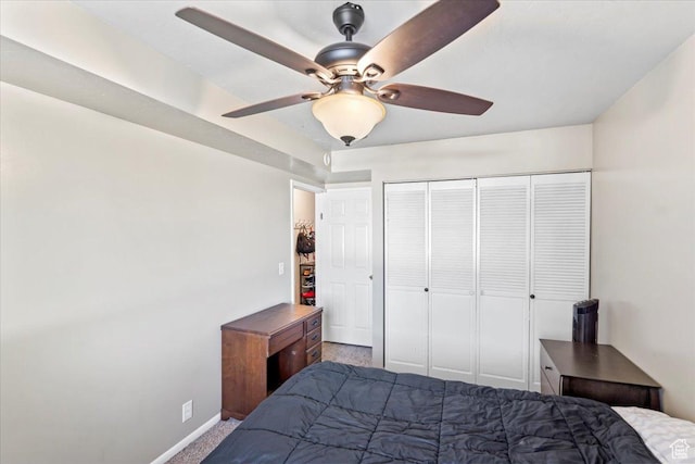 carpeted bedroom with baseboards, a closet, and a ceiling fan