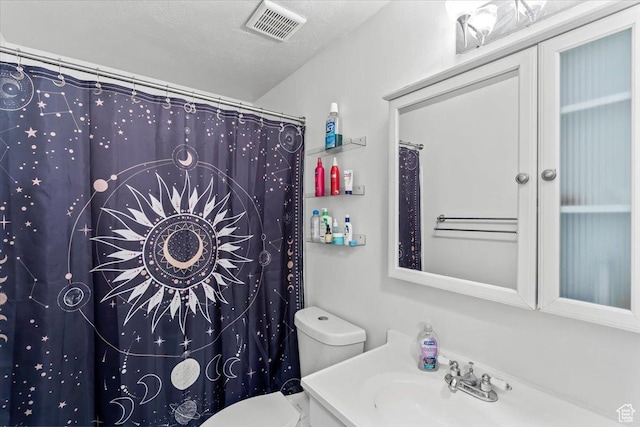 bathroom featuring toilet, vanity, and curtained shower