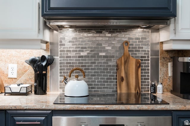 3000 Canyons Resort Dr Unit 3716, Park City, UT 84098 - kitchen view of tasteful backsplash, black electric cooktop, white cabinetry, oven, and blue cabinetry