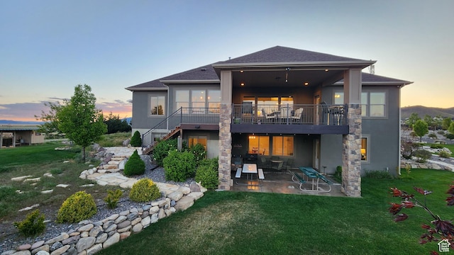 9288 N Harmony Way, Eagle Mountain, UT 84005 - rear view of property with a patio area, stairway, and a yard