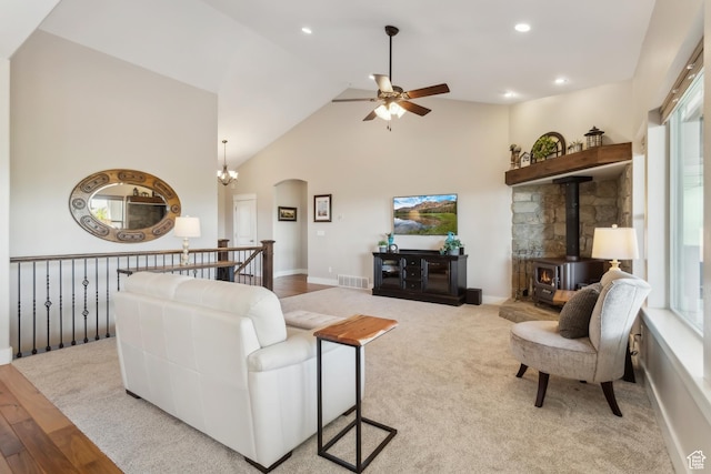 9288 N Harmony Way, Eagle Mountain, UT 84005 - living area featuring a ceiling fan, arched walkways, a wood stove, high vaulted ceiling, and recessed lighting