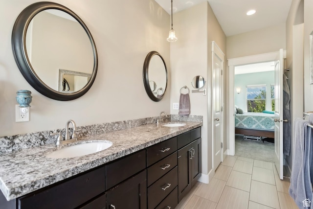9288 N Harmony Way, Eagle Mountain, UT 84005 - ensuite bathroom with double vanity, baseboards, and tile patterned flooring