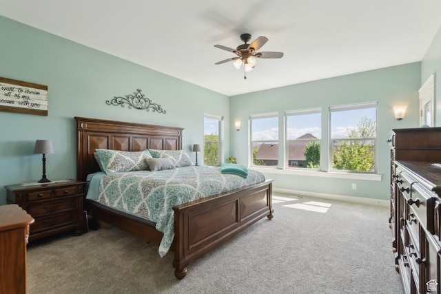 9288 N Harmony Way, Eagle Mountain, UT 84005 - bedroom featuring multiple windows, carpet, a ceiling fan, and baseboards