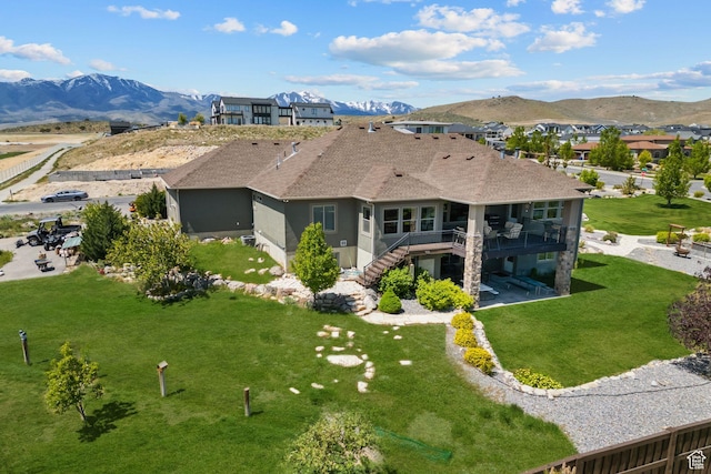9288 N Harmony Way, Eagle Mountain, UT 84005 - rear view of house featuring stairs, a deck with mountain view, a lawn, roof with shingles, and stucco siding