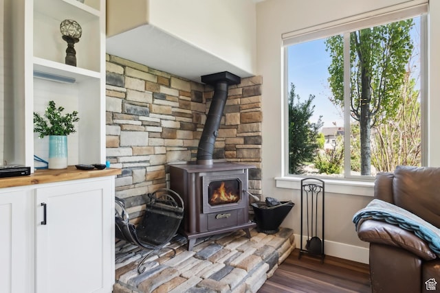 9288 N Harmony Way, Eagle Mountain, UT 84005 - detailed view of a wood stove, baseboards, and wood finished floors