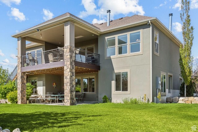 9288 N Harmony Way, Eagle Mountain, UT 84005 - rear view of property featuring stucco siding, a yard, a patio, and a balcony