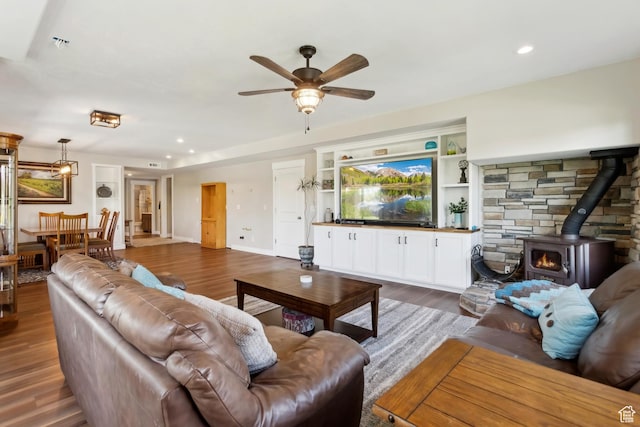 9288 N Harmony Way, Eagle Mountain, UT 84005 - living room featuring a wood stove, ceiling fan, wood finished floors, recessed lighting, and baseboards